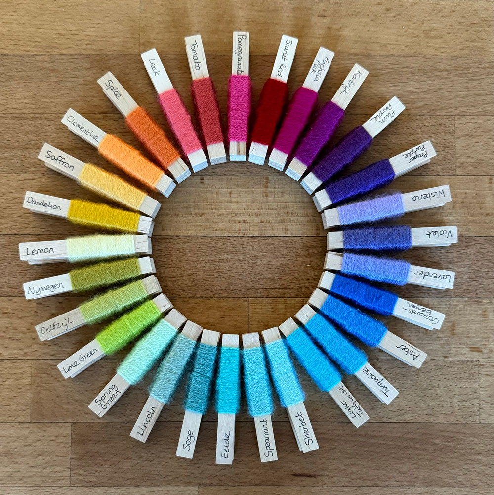 Spiral of yarn pegs forming a rainbow